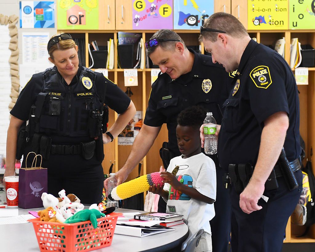 Ashton Dixon shows police officers his classroom toys